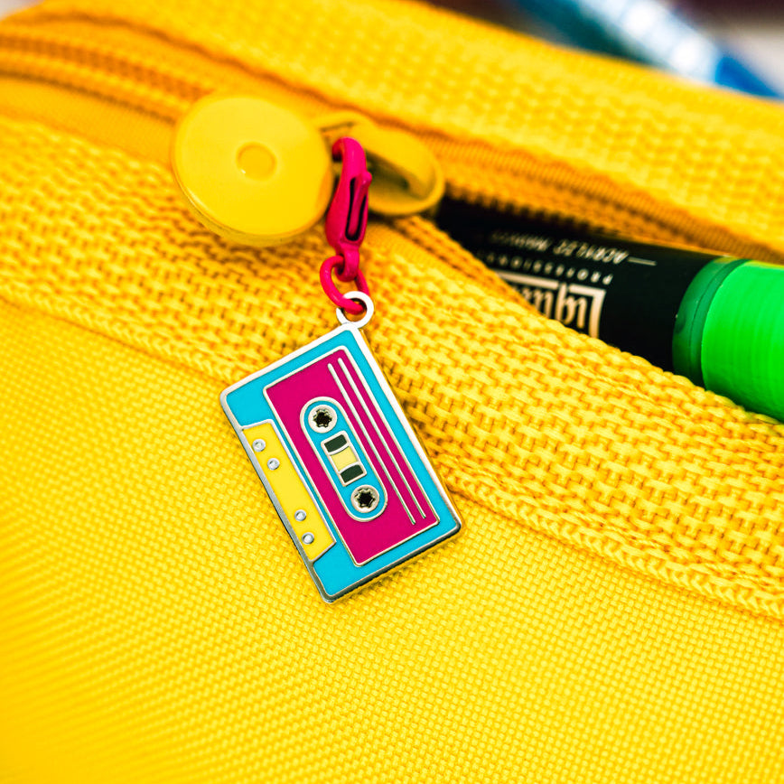 Yellow pencil case with a colorful cassette tape charm from Spot Studio Art