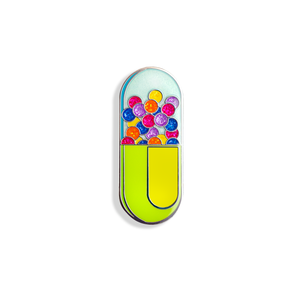 A colorful enamel pin in the shape of a capsule with a glittery, pill-like design.