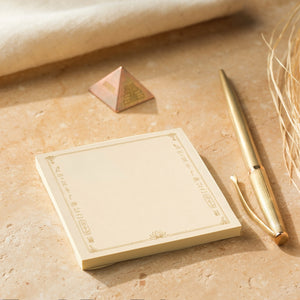 Egyptian Post-it notes styled beside a gold-colored pen