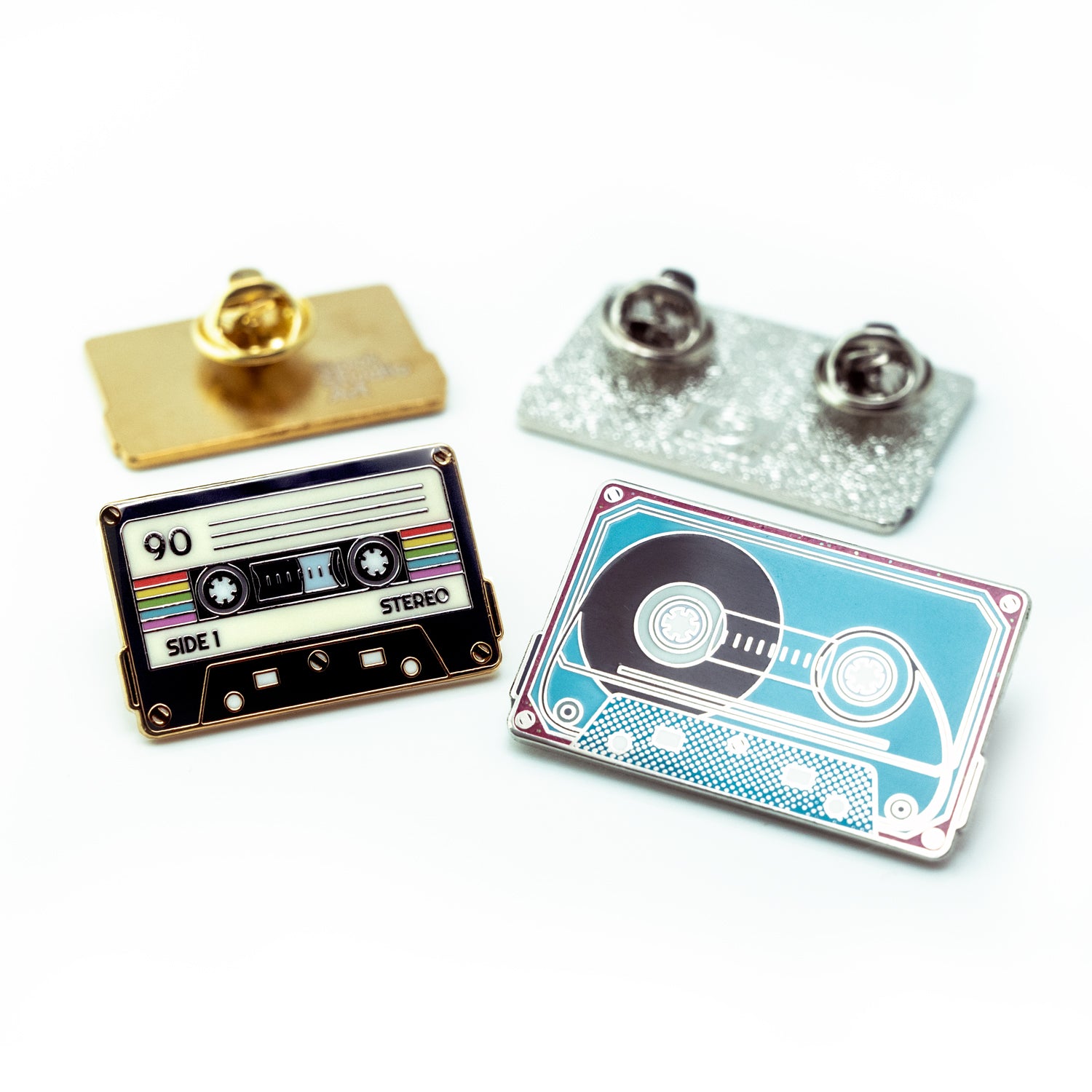 Two cassette tape-themed pins on a white background