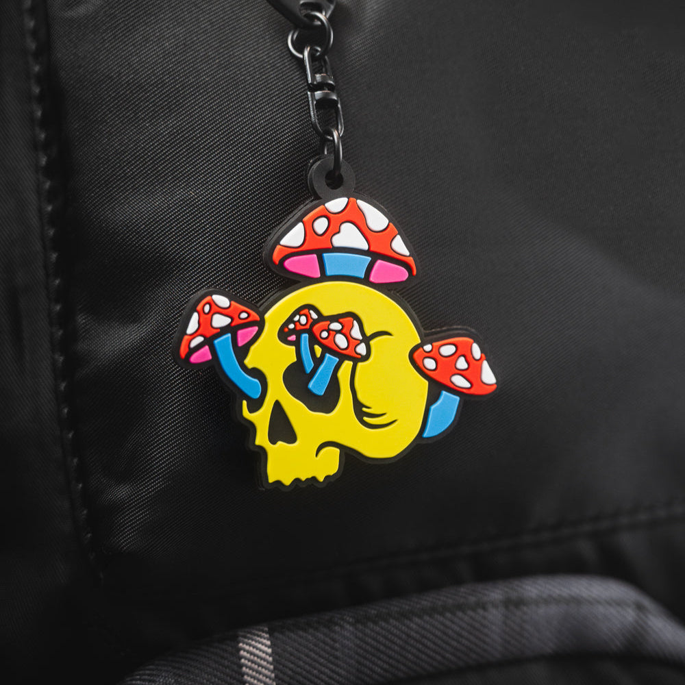 Colorful Shroom Skull keychain charm with on a black backpack from Spot Studio Art.