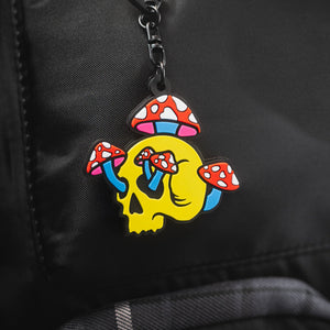 Colorful Shroom Skull keychain charm with on a black backpack from Spot Studio Art.