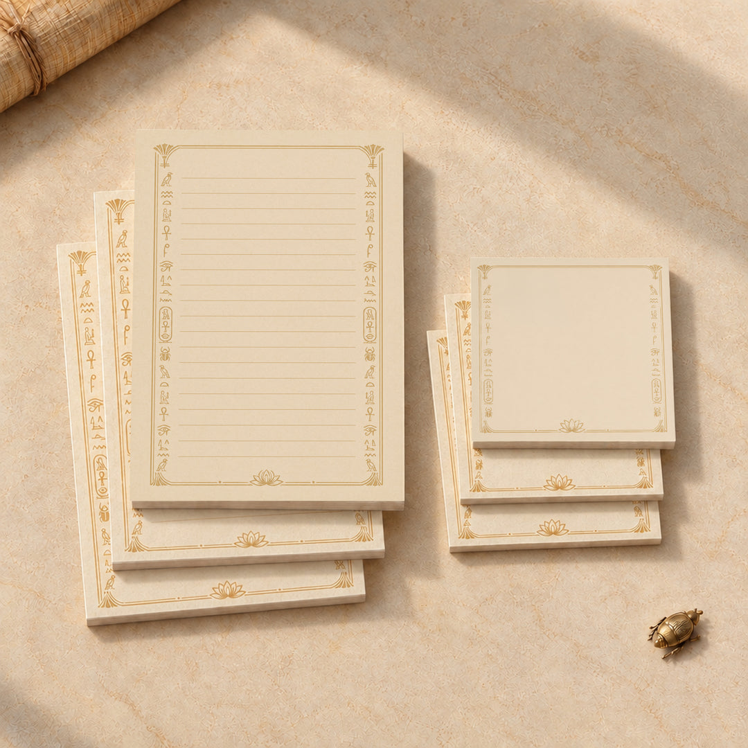 Overhead view of the complete Egyptian stationery set with three lined notepads and three square Post-it note pads