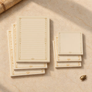 Overhead view of the complete Egyptian stationery set with three lined notepads and three square Post-it note pads