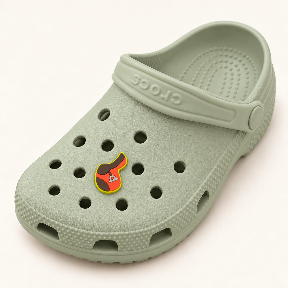 Full sage-green Croc displaying one small English saddle shoe charm; shoe shown for styling only.