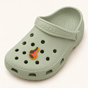 Full sage-green Croc displaying one small English saddle shoe charm; shoe shown for styling only.