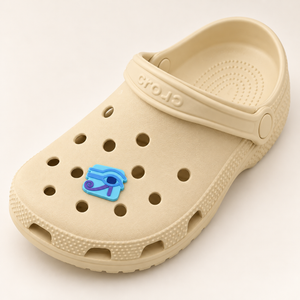 Full buttercream Croc displaying one small Eye of Horus shoe charm; shoe shown for styling only.