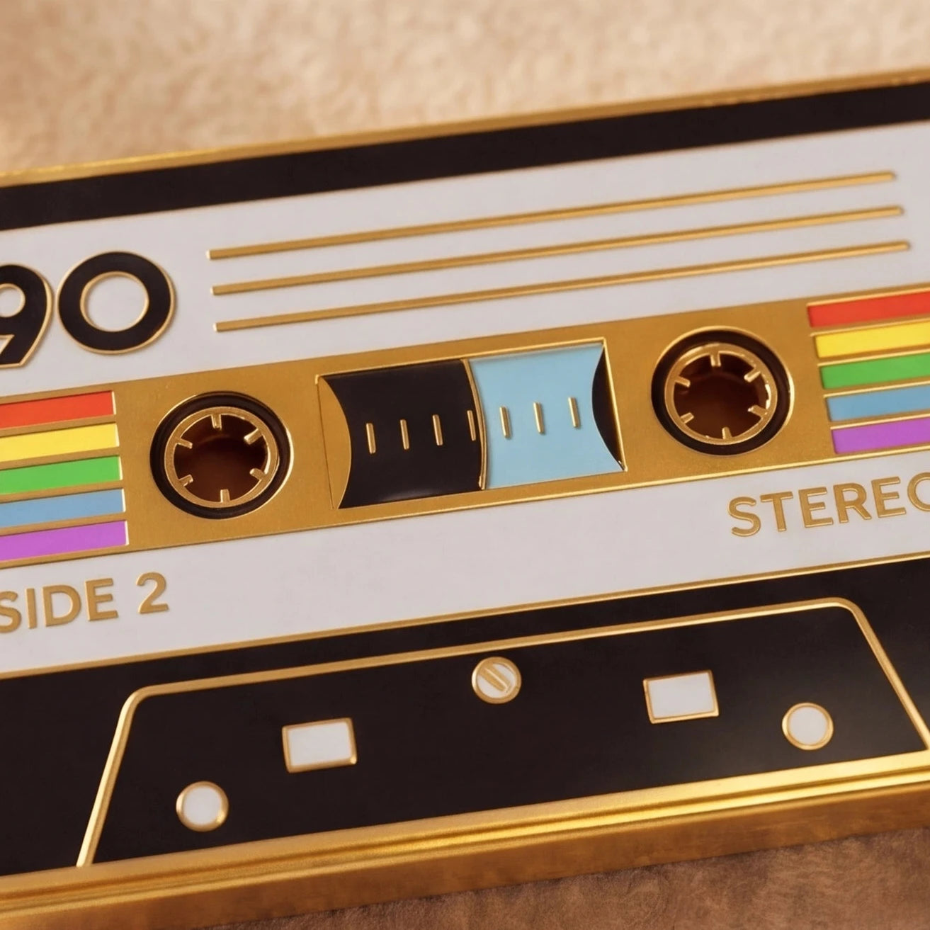 Close-up of a retro-style cassette tape with rainbow colors on a beige background