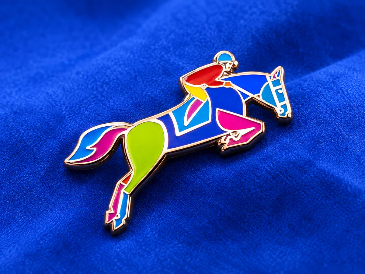 Colorful horse and rider enamel pin on a cobalt blue surface